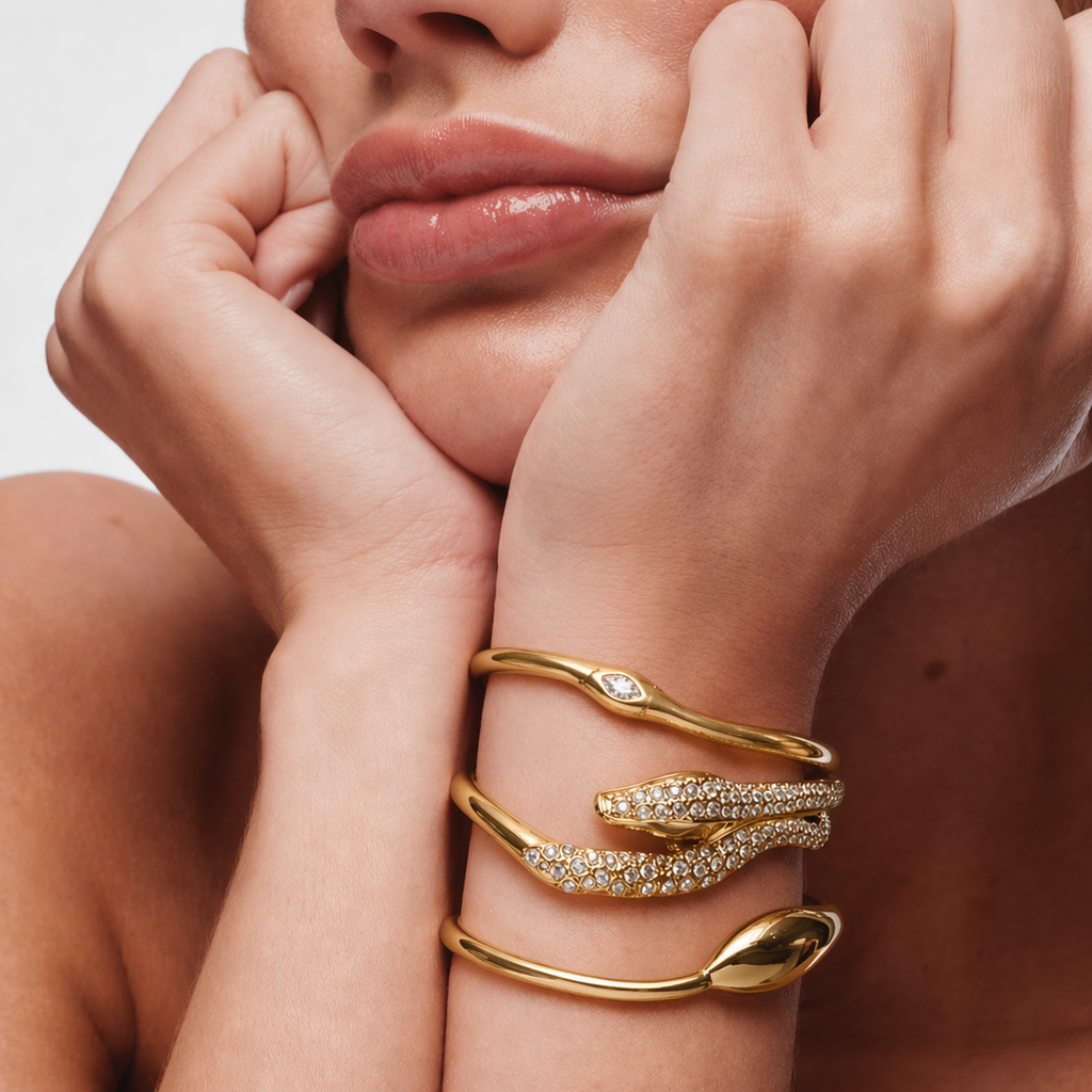 Model wearing a gold-plated stainless steel snake bracelet with zircon and other plated jewelry, highlighting waterproof qualities.