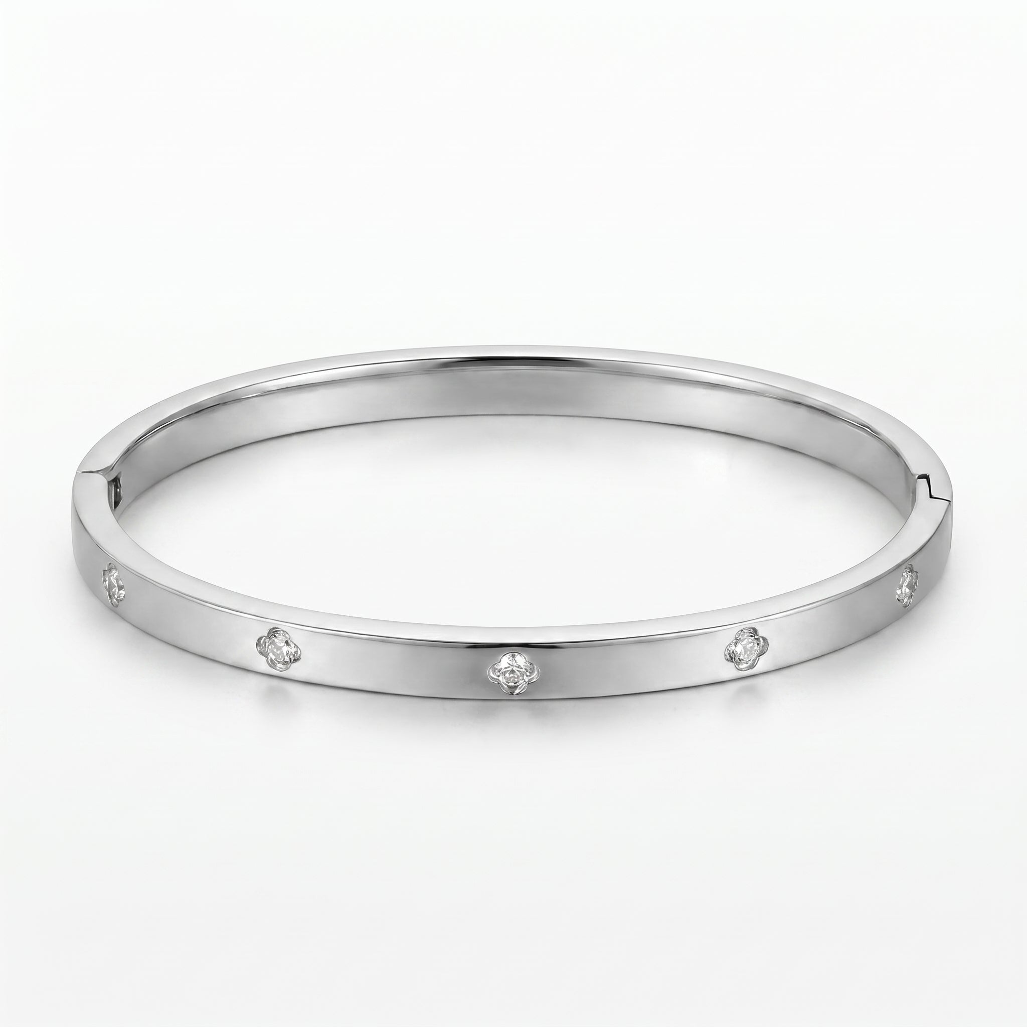 Woman wearing a gold-tone titanium steel Eclipse Bangle with sparkling zircon embellishments, paired with an orange top and matching gold necklace.