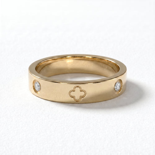 Studio shot of the exquisite 18K gold clover diamond ring, highlighting the brilliant-cut diamonds and intricate four-leaf clover design on a pristine white background.