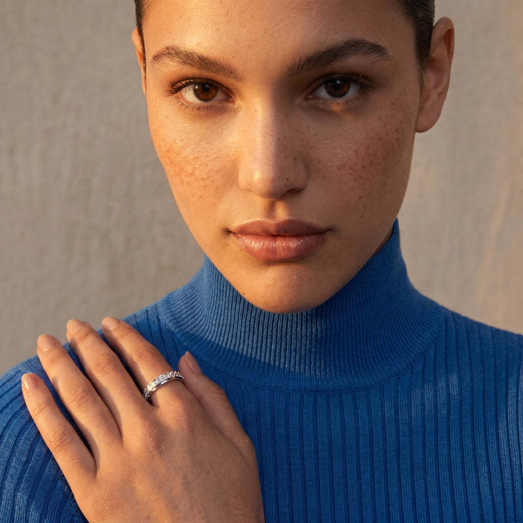Portrait of a woman wearing the Thadeos Motion Diamond Band, with warm lighting accentuating its brilliance and her refined style.