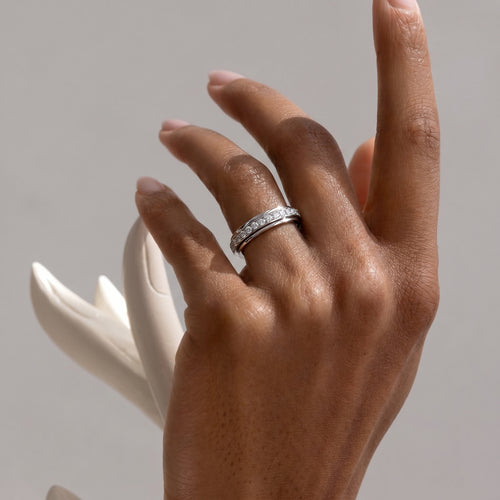Elegant lifestyle shot of a Motion Diamond Band on a hand, highlighting its sophisticated design and how it beautifully adorns the finger.