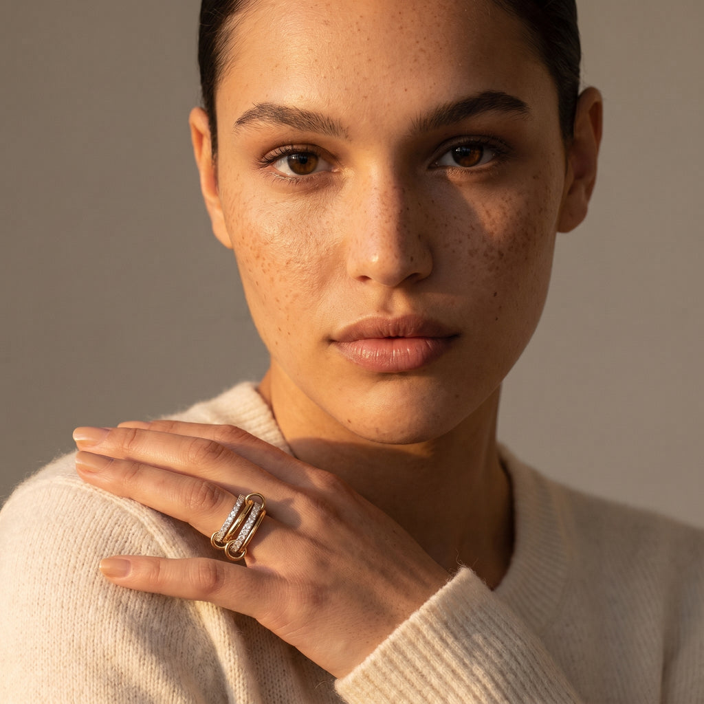 Elegant woman wearing the 18k gold Linked Pavé Diamond Ring, showing its sophisticated presence on her finger and complementing her natural beauty.