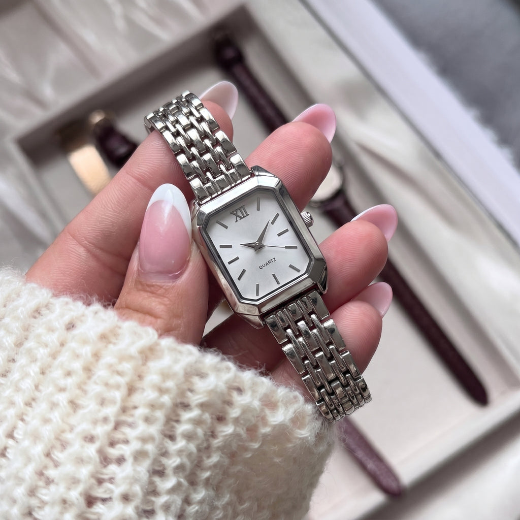 Silver-tone Radian Square Quartz Watch with white dial, held by hand, highlighting refined craftsmanship