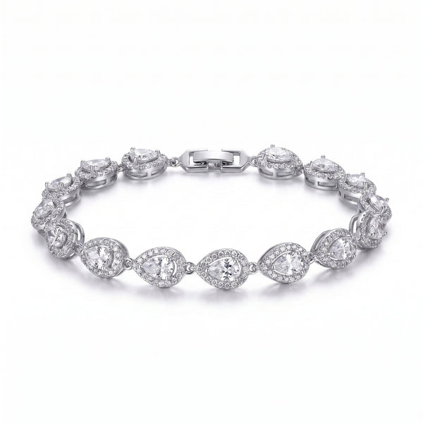 A woman's arm wearing a sparkling rhodium-plated bracelet featuring pear-cut zircon stones, each framed by a pave halo, exuding refined elegance.