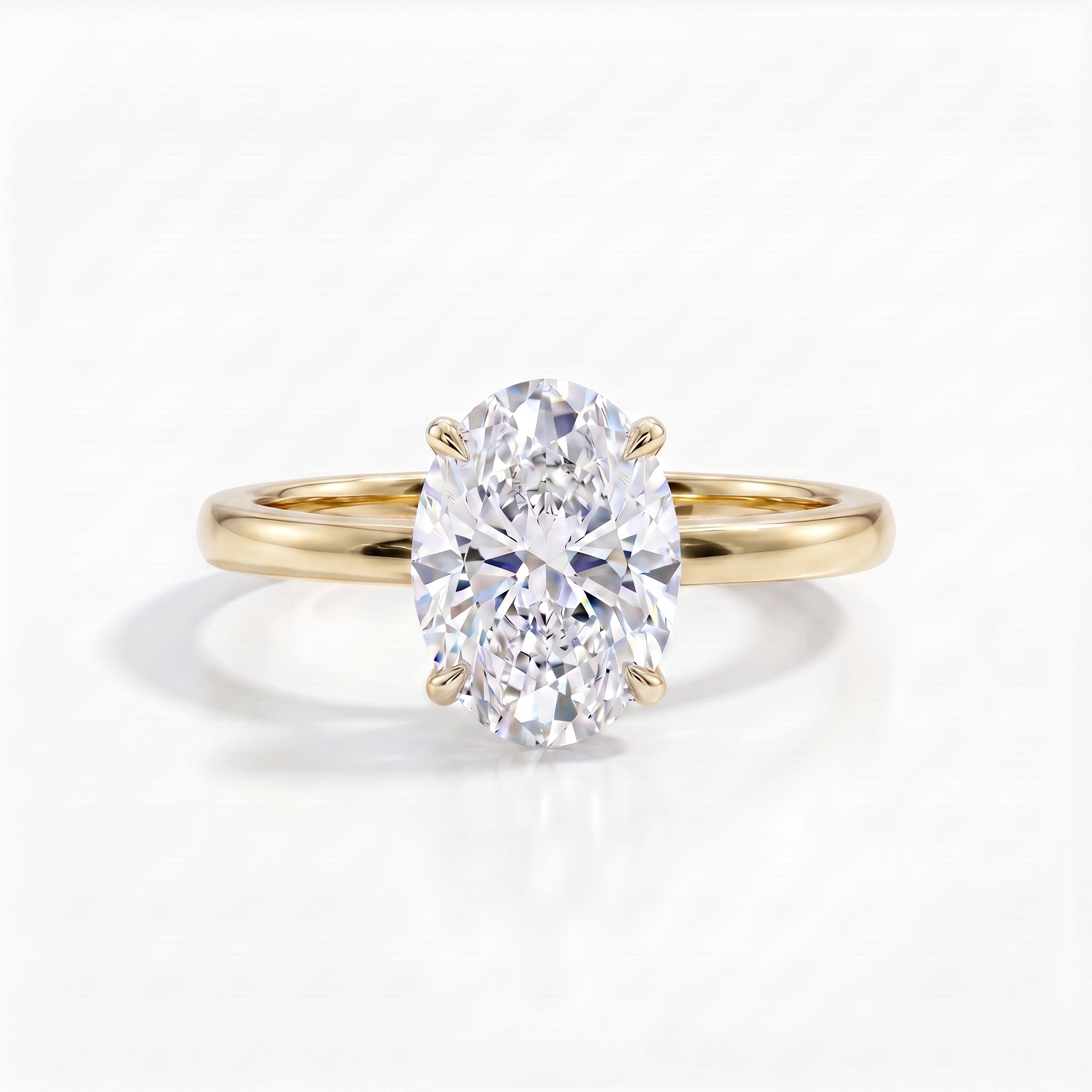 A radiant oval-cut diamond solitaire ring set in a polished 18k yellow gold band, casting a soft shadow on a pristine white surface.