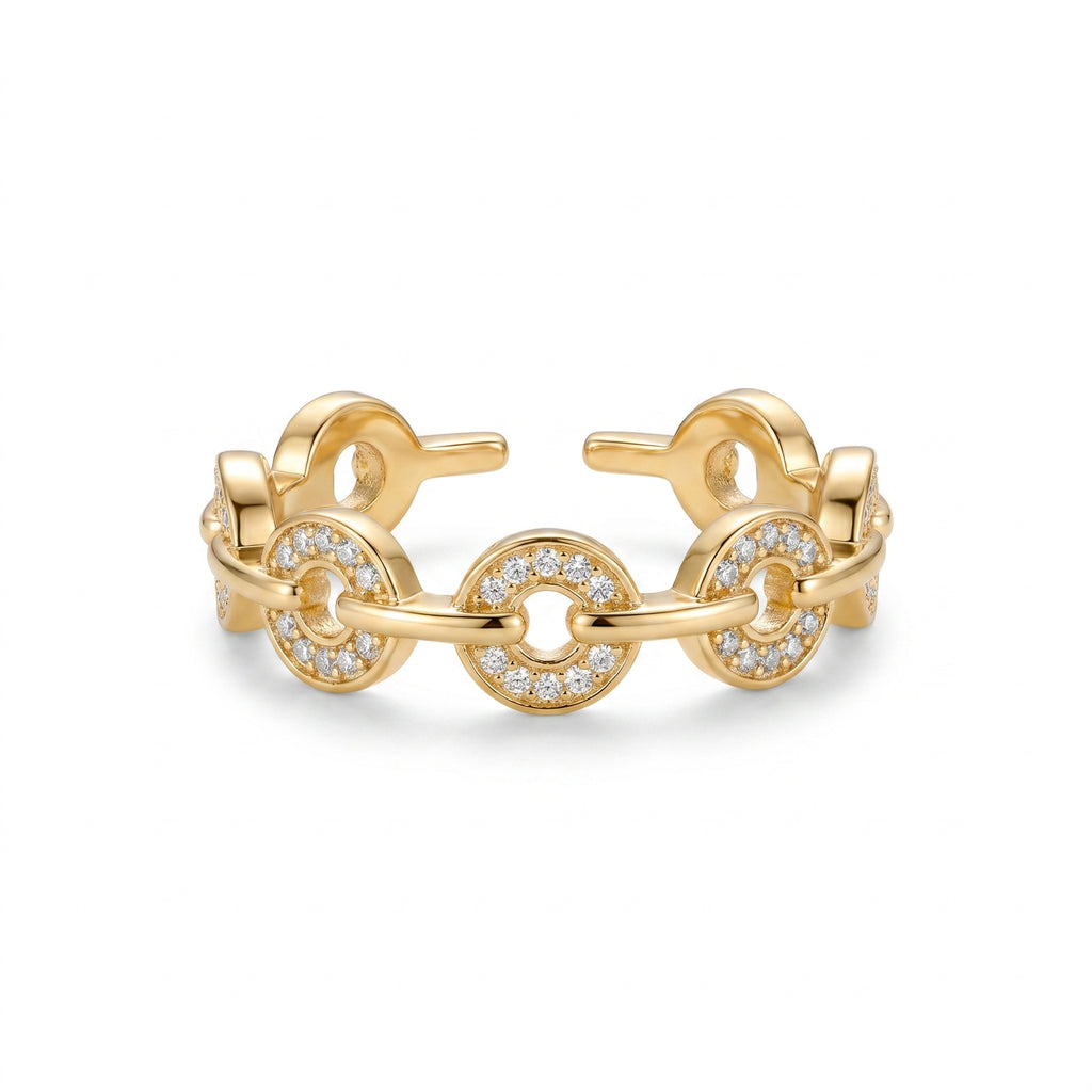 Detailed close-up of the gold-plated Pavé Link Ring featuring brilliant pavé zirconia on circular links and an adjustable open band, set against a pristine white background.