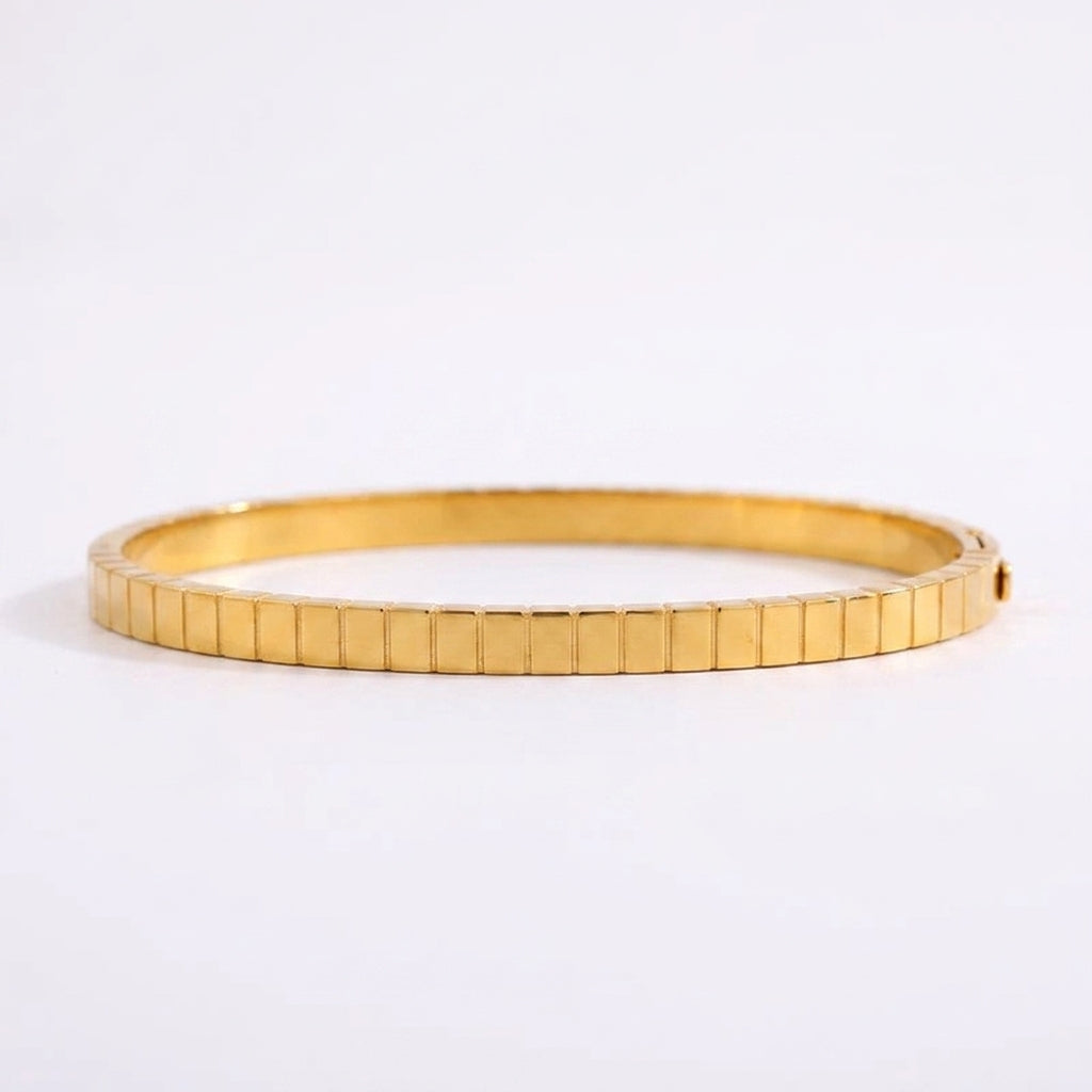 Close-up of the geometric detailing on a silver titanium steel plated bracelet, showcasing its modern texture.