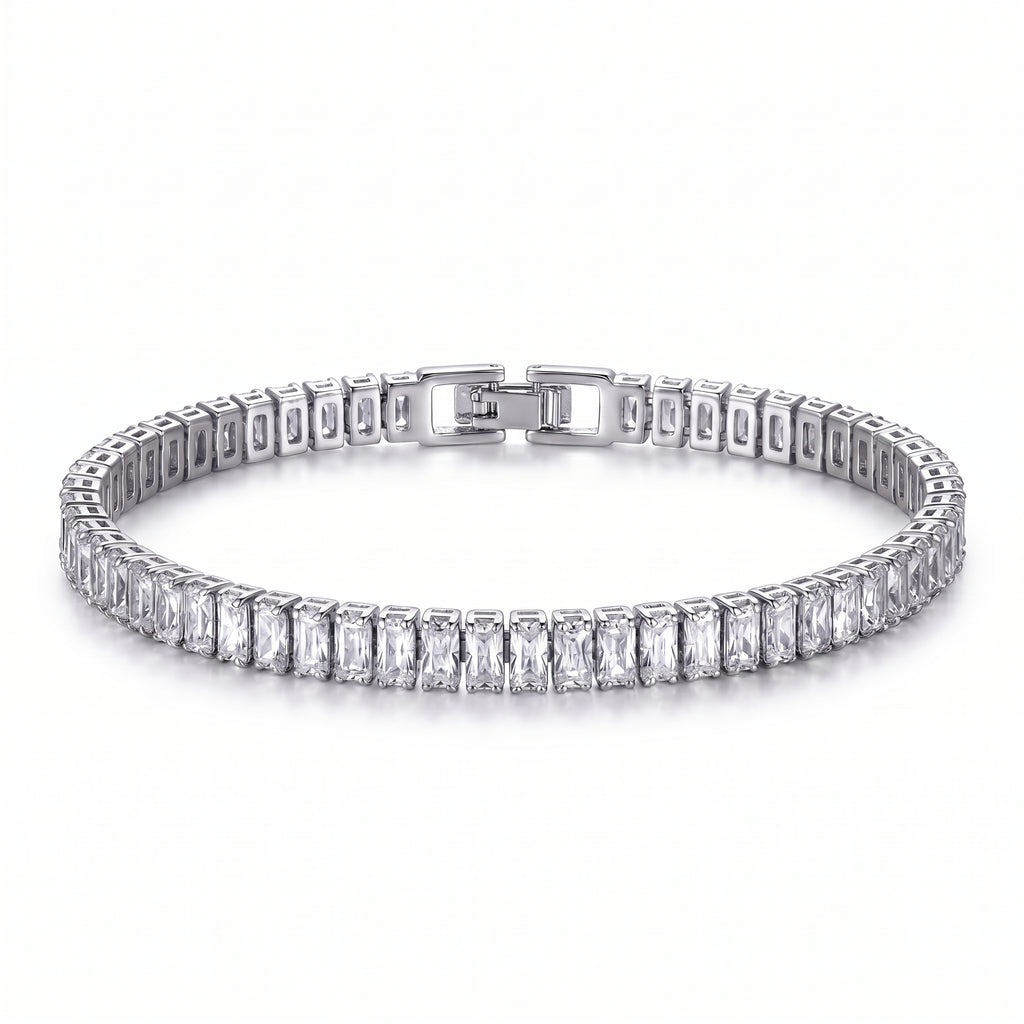 Close-up of a platinum-plated tennis bracelet with brilliant baguette-cut zircon stones and a secure box clasp, against a white background.