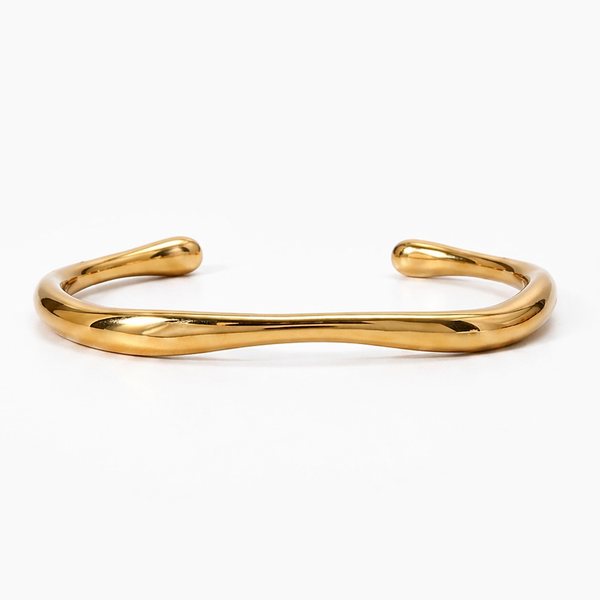 18K gold-plated stainless steel cuff bracelet with a fluid, organic design. Reflective, waterproof, and affordable jewelry.