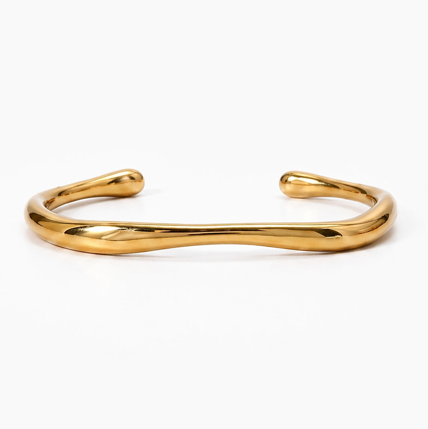 18K gold-plated stainless steel cuff bracelet with a fluid, organic design. Reflective, waterproof, and affordable jewelry.